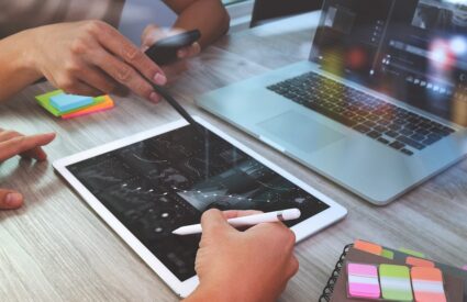 Co-workers looking at data designs