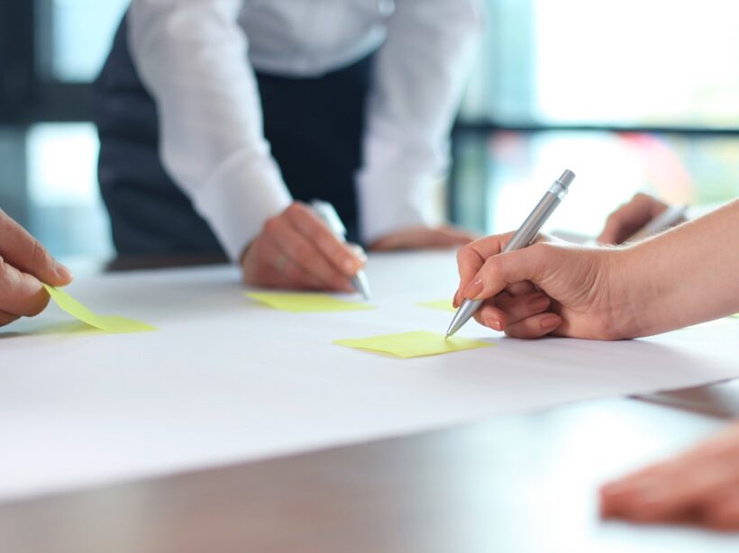 mage of business people hands working with papers at meeting