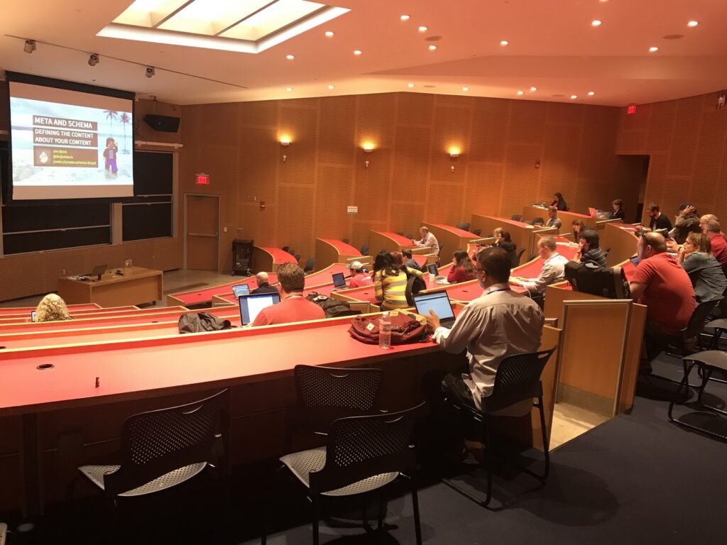 Image of Jim Birch's presentation in a large classroom with a projector screen at Design 4 Drupal