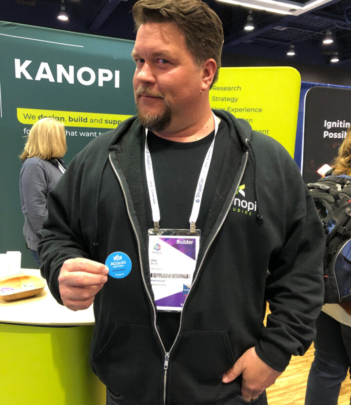 Jim Birch holding his Acquia certification badge