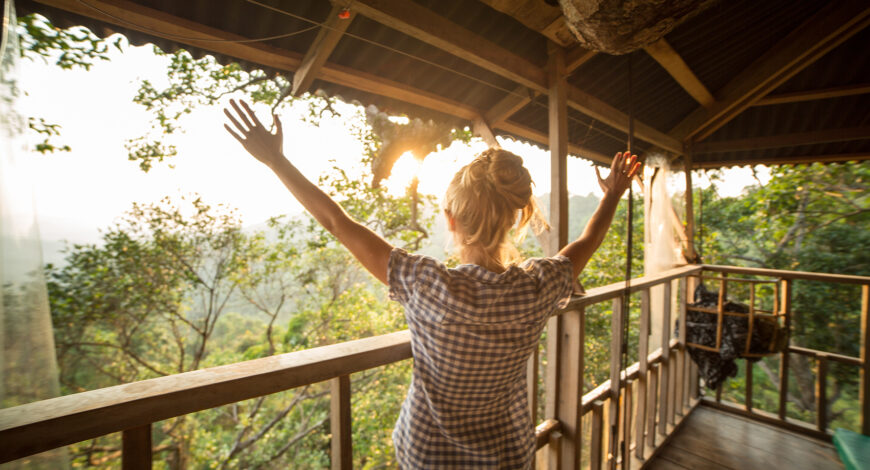 Woman with her arms raised to the sky