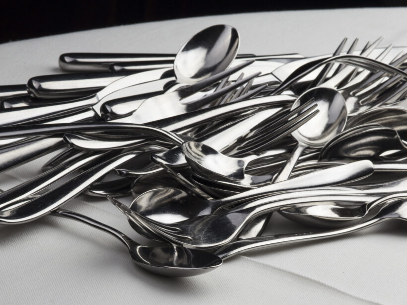 A pile of silver forks, knives and spoons haphazardly dumped in a pile, demonstrating the messiness of a site not using custom post types..