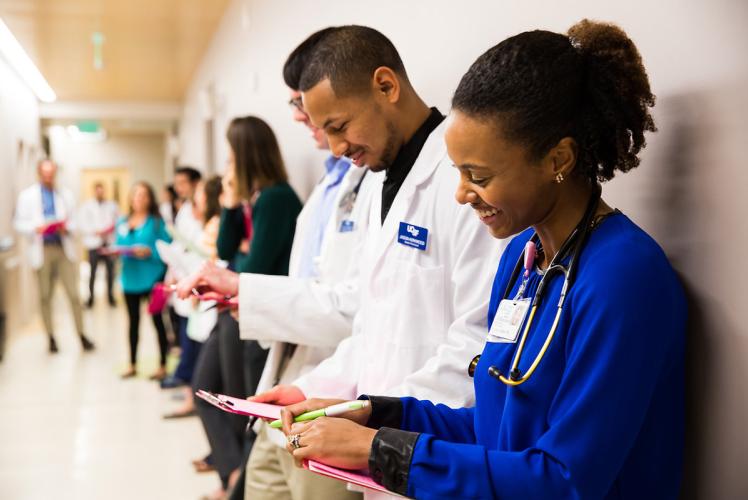 UCSF Nurses lined up against a wall and smiling