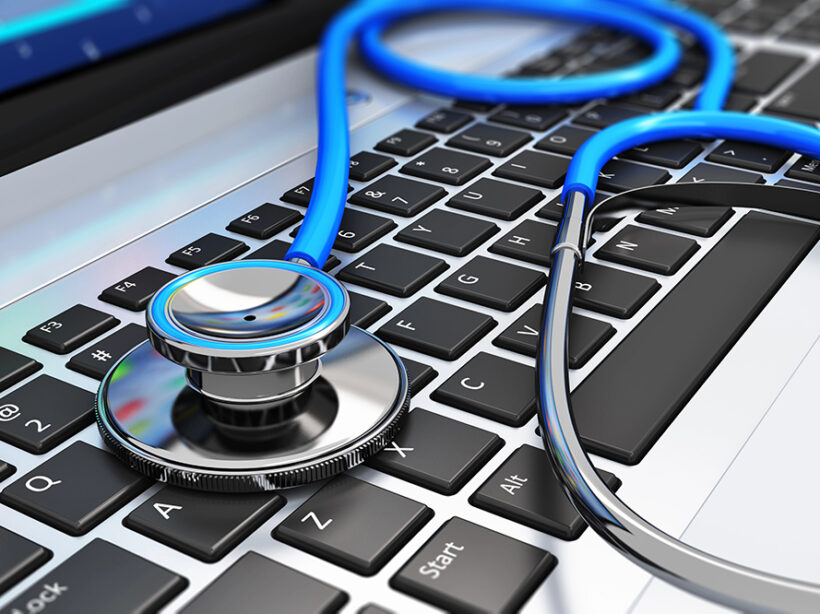 A stethoscope sitting on a laptop keyboard