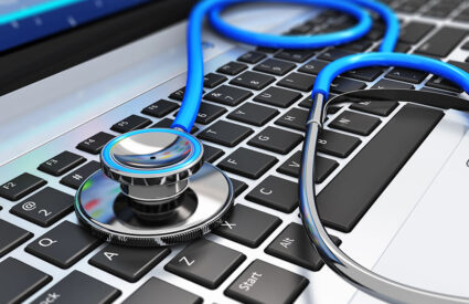 A stethoscope sits on a laptop keyboard