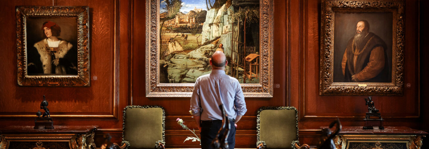 A man standing in front of a painting at the Frick Collection