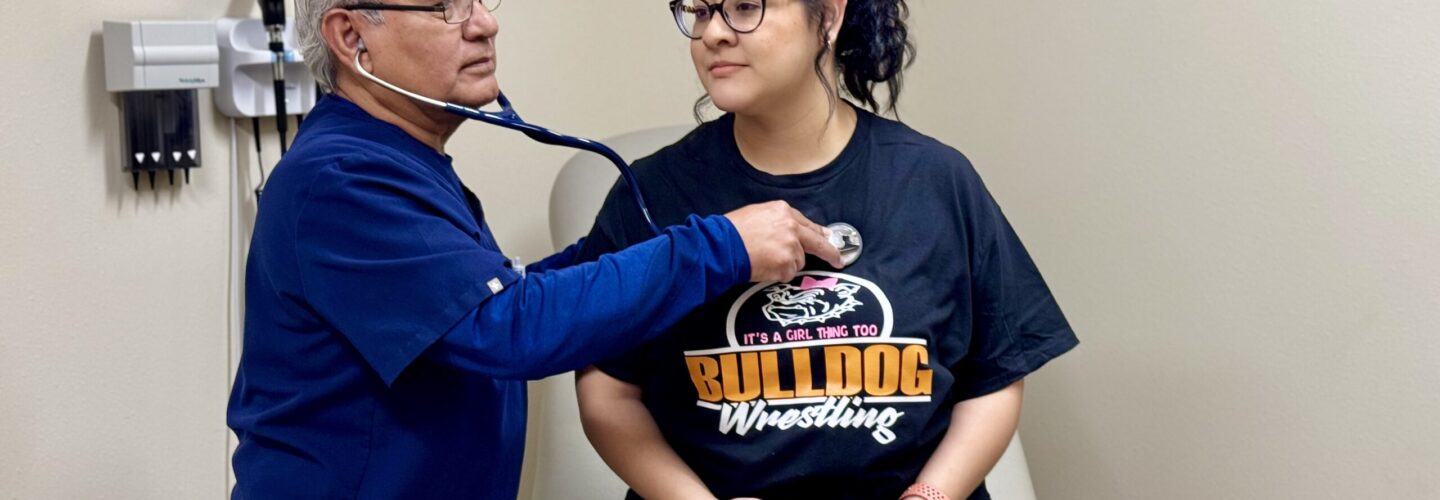 Male nurse checking the heartbeat of a female patient